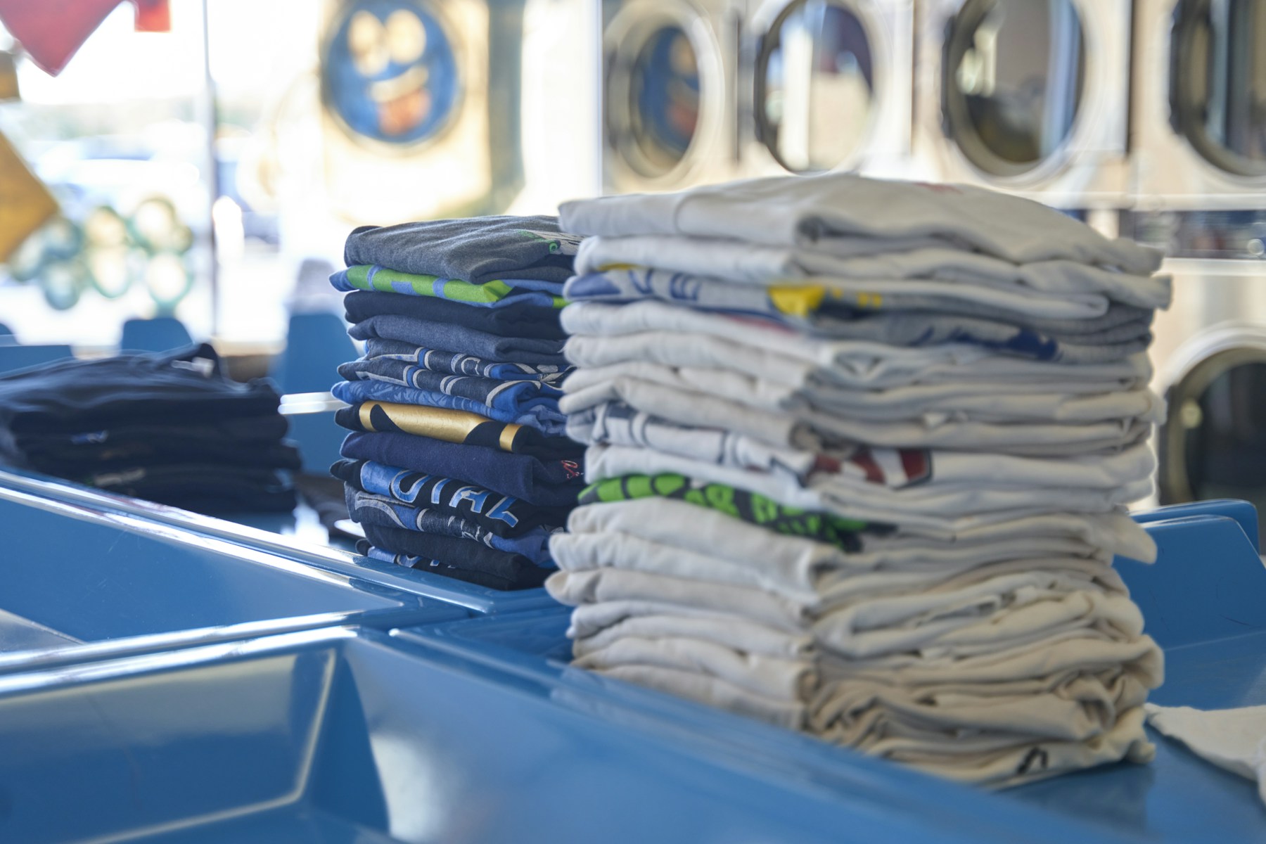 A stack of clean, fully dried folded shirts stored in an airy wardrobe.